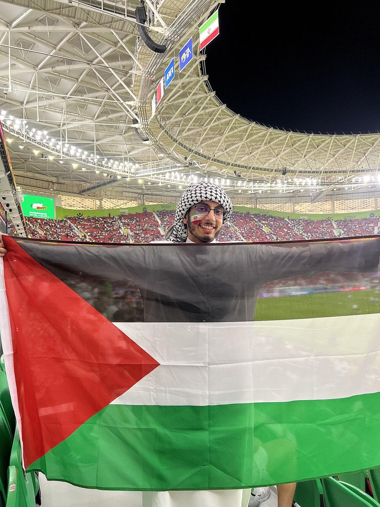 Fans with a Palestinian flag at the 2022 World Cup in Qatar